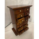 A MINIATURE MAHOGANY FOURTEEN DRAWER CABINET H:32CM