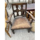 AN EARLY 20TH CENTURY OAK LOW ELBOW CHAIR