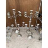 A PAIR OF FOUR BRANCH METAL CANDLE STICKS AND A FURTHER PAIR OF TWO BRANCH METAL CANDLE STICKS