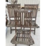 A SET OF THREE FOLDING TEAK GARDEN CHAIRS