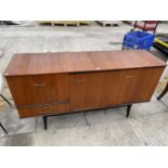 A RETRO TEAK SIDEBOARD ENCLOSING BI-FOLD AND SINGLE DOORS, ONE DRAWER ON BLACK LEGS, 60" WIDE