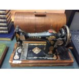 A VINTAGE SINGER SEWING MACHINE IN A CASE