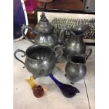 A DECORATIVE FOUR PIECE PEWTER TEA SET TO INLCUDE A TEAPOT, WATER JUG, MILK JUG AND SUGAR BASIN