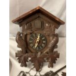 A CARVED WOODEN CUCKOO CLOCK WITH ONE WEIGHT