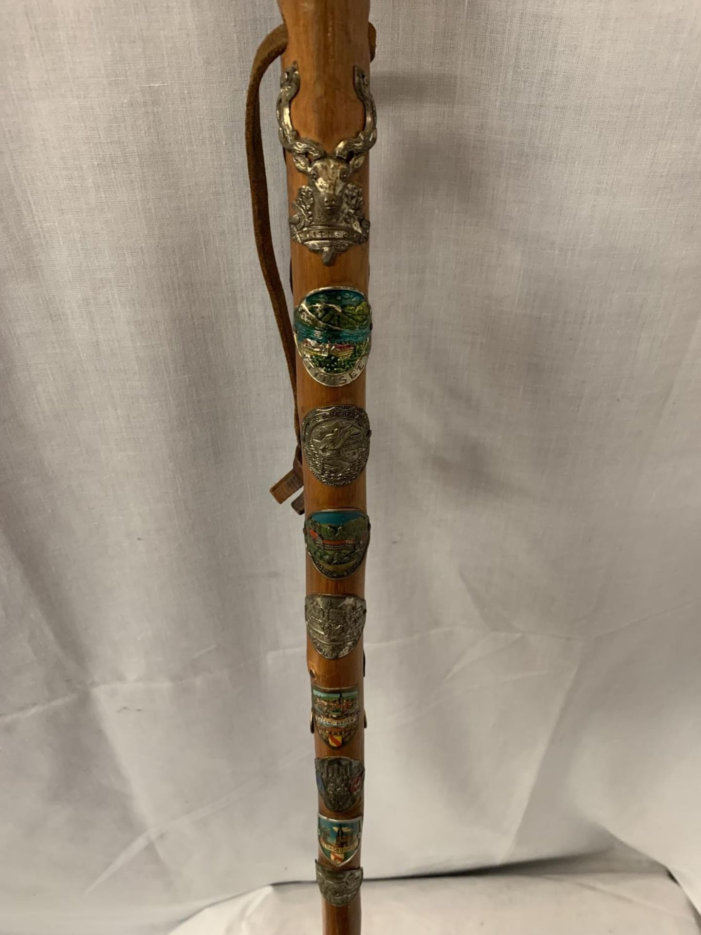 A WOODEN WALKING CANE WITH METAL TIP, LEATHER STRAP AND VARIOUS BADGES FROM THE ALPS - Image 2 of 3
