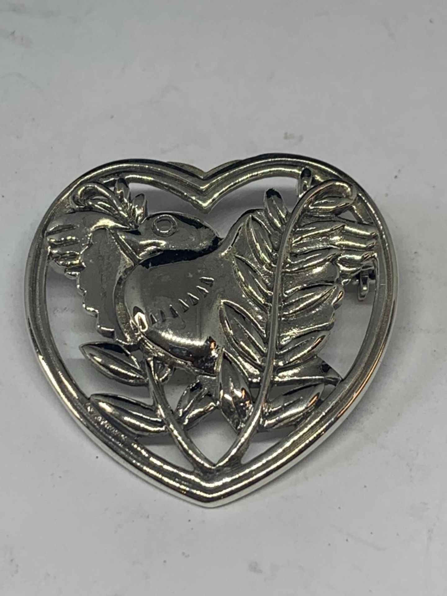 A MARKED DENMARK SILVER HEART SHAPED BROOCH WITH BIRD AND LEAF DESIGN