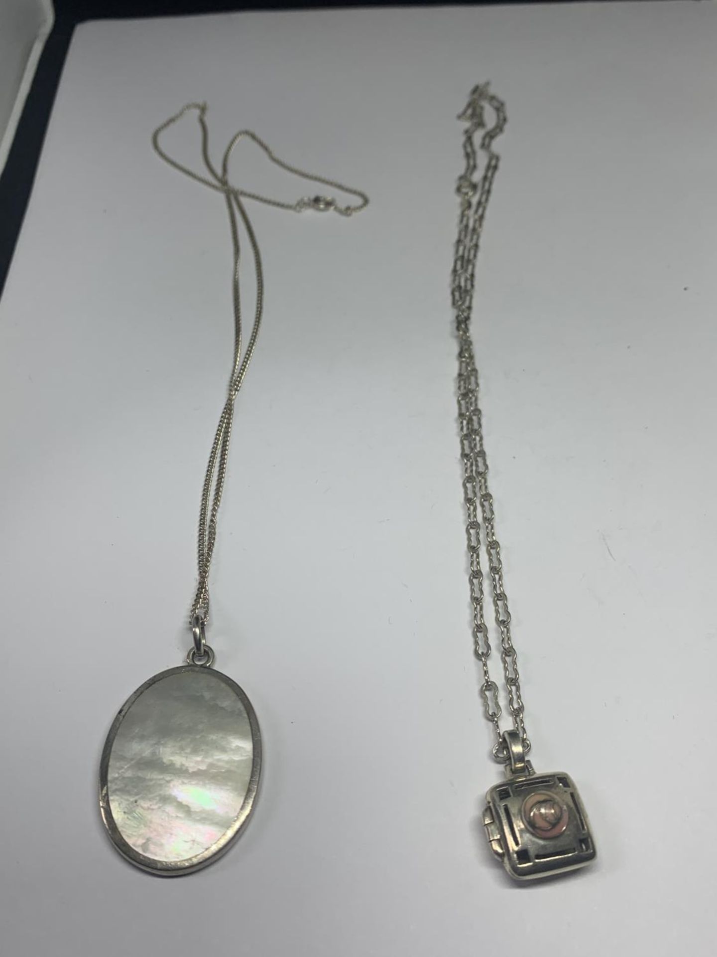 TWO SILVER NECKLACES WITH PENDANTS