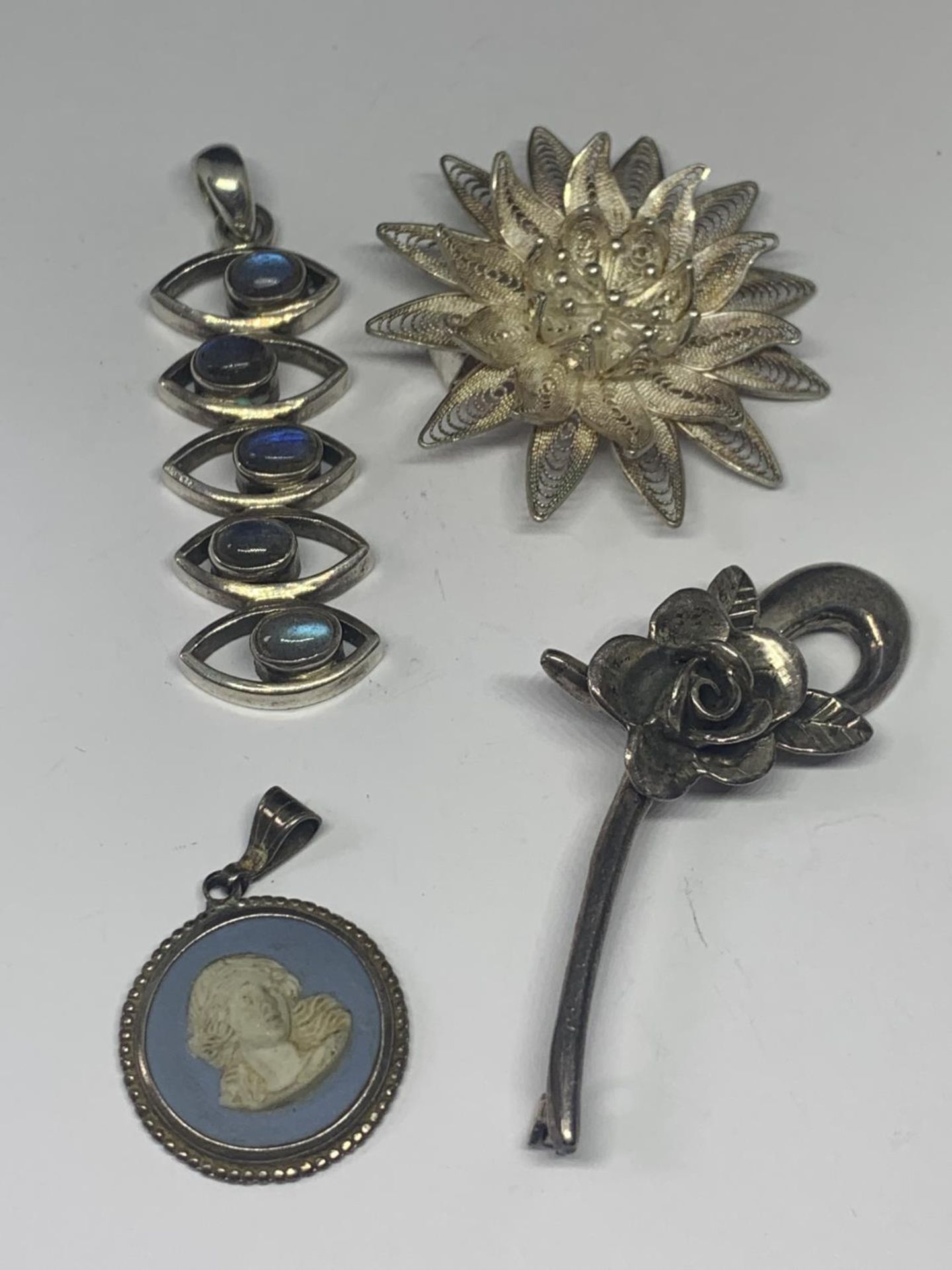 FOUR SILVER ITEMS TO INCLUDE TWO BROOCHES AND TWO PENDANTS