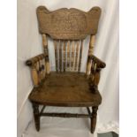 A CHILD'S BEECH SPINDLE BACK CARVED ELBOW CHAIR, HEIGHT 66CM, ONE FOOT MISSING, PREVIOUS WOODWORM (