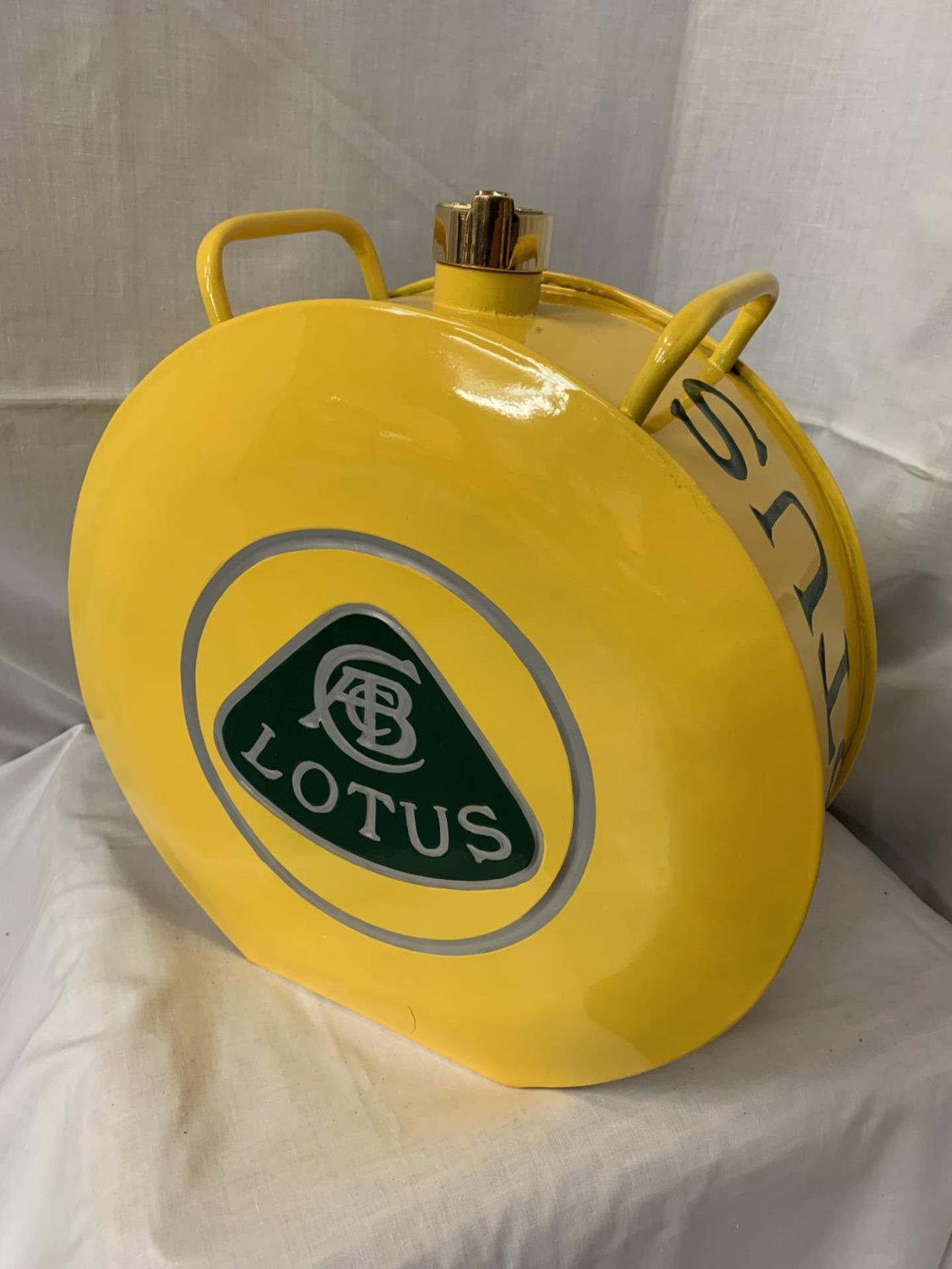 A YELLOW LOTUS PETROL CAN WITH BRASS STOPPER