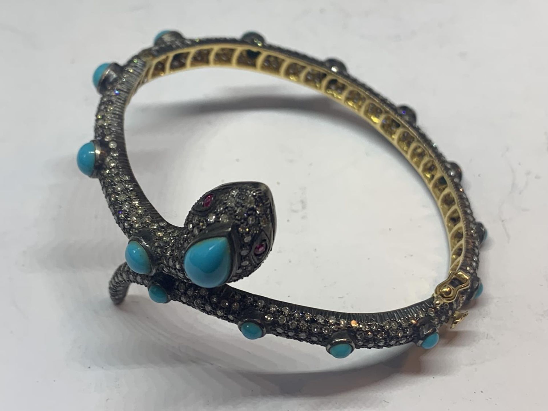 A GOLD AND WHITE GOLD SNAKE BANGLE ENCRUSTED WITH DIAMONDS, RUBY EYES AND BLUE NAJAVO STONES - Image 5 of 10