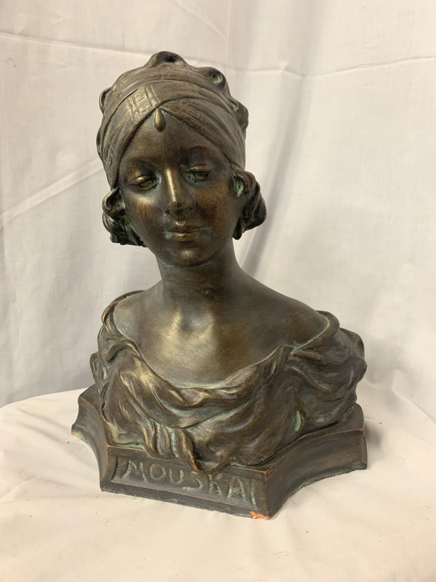 A BRONZED STONE BUST OF AN ART DECO LADY H 42CM