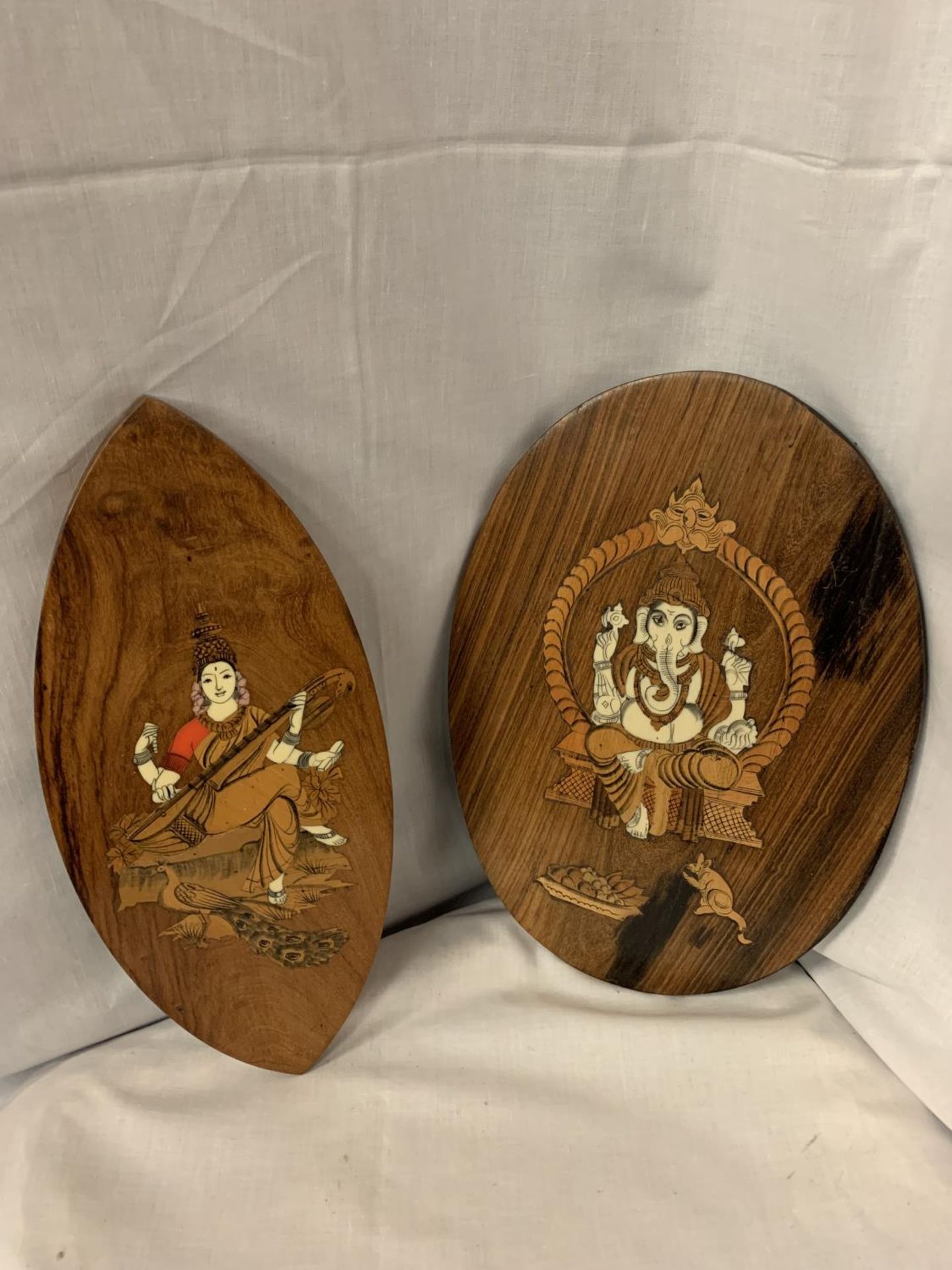 TWO HEAVILY DECORATED WOODEN WALL HANGING PLAQUES WITH ORNATE INLAY ORIENTAL SCENES