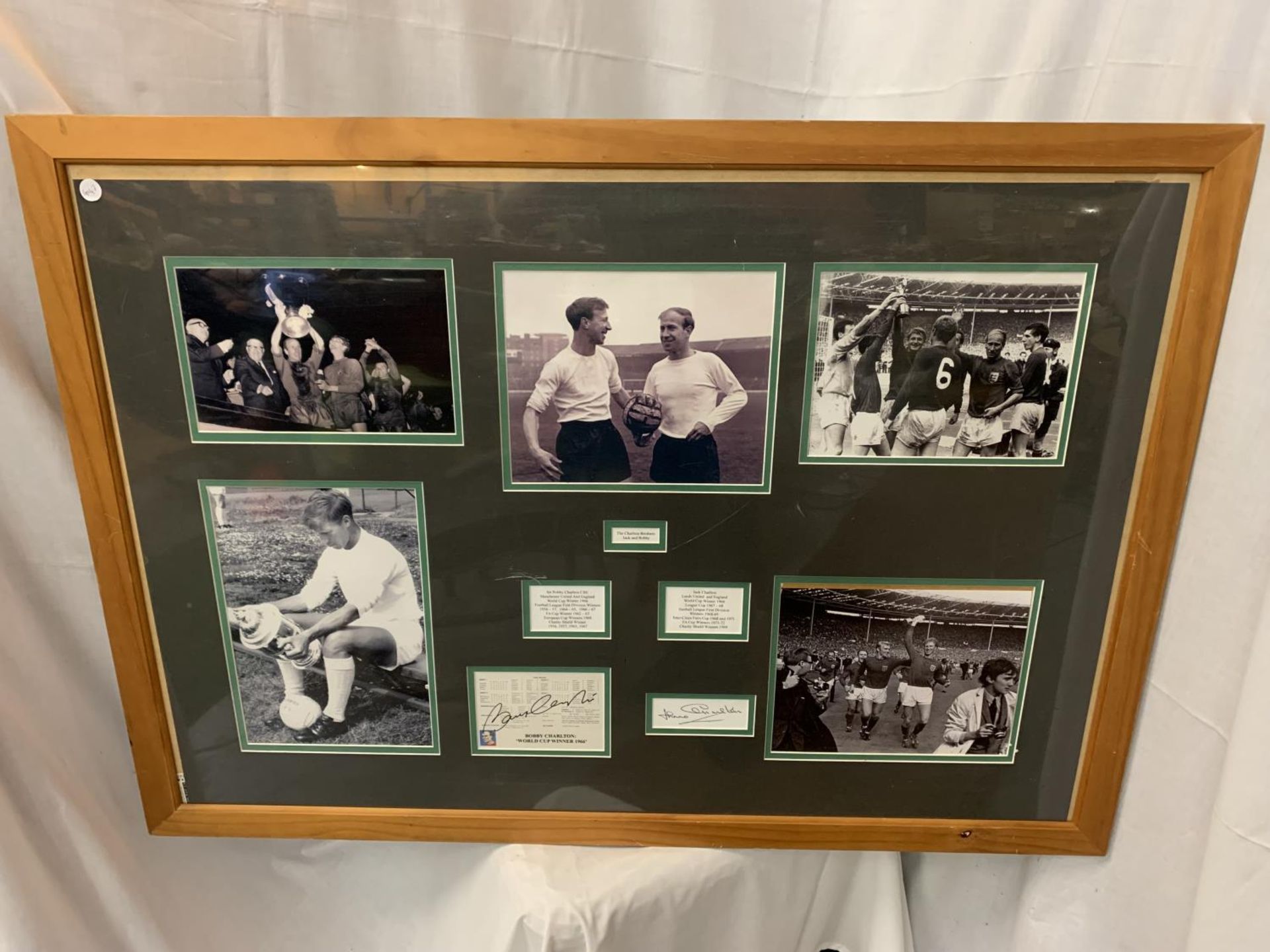 A LARGE FRAMED AND MOUNTED MULTI-PICTURE AND AUTOGRAPHED DISPLAY OF THE CHARLTON BROTHERS JACK AND