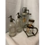 TWO VINTAGE GLASS BUTTER CHURNS TOGETHER WITH TWO VINTAGE SODA SYPHONS, ONE 'CORNWELL'S AERATED