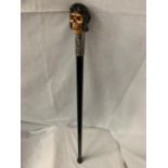 A WALKING STICK WITH A STEAMPUNK STYLE SKULL HEAD HANDLE