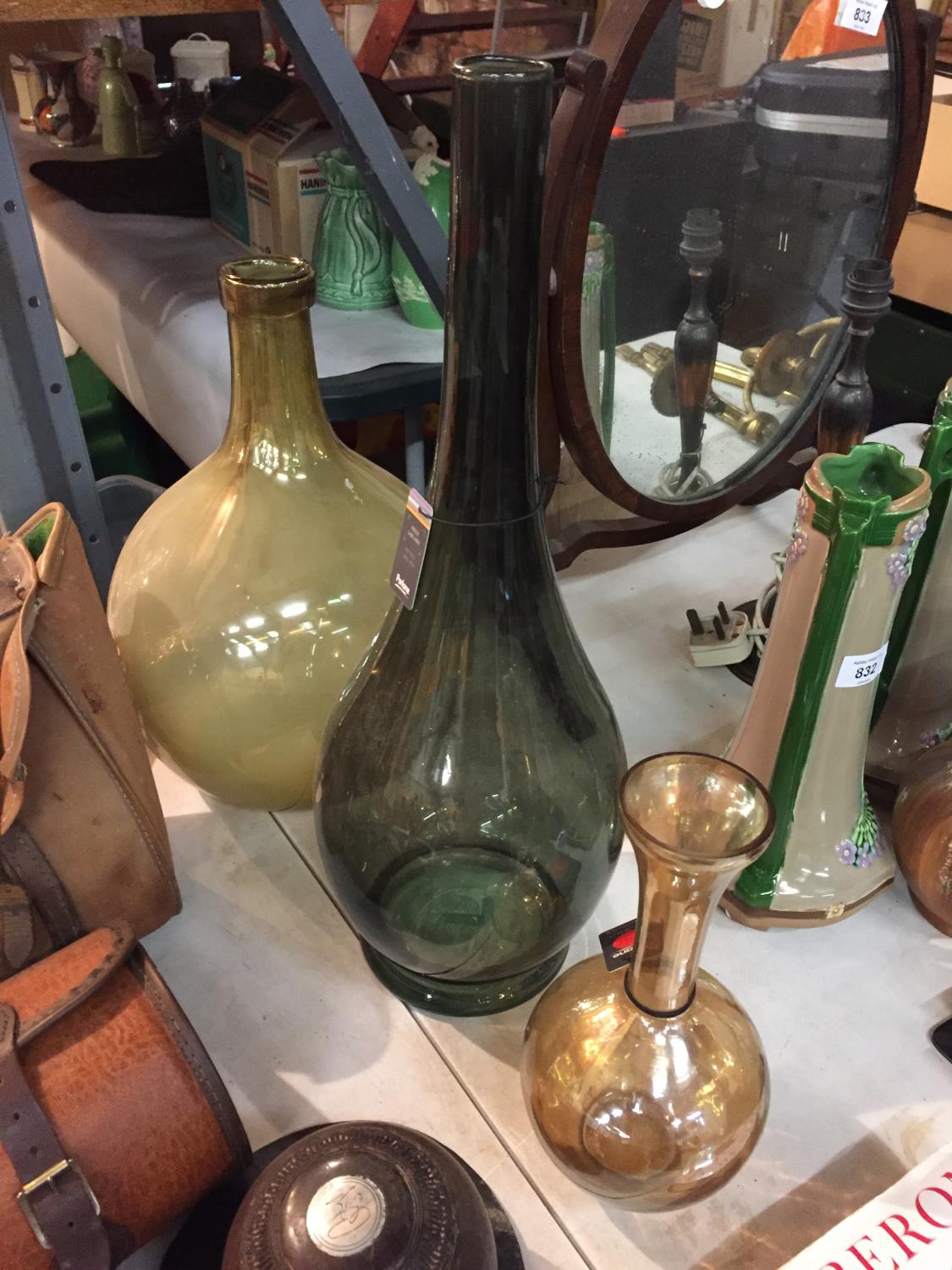 THREE TALL COLOURED GLASS BOTTLES/VASES