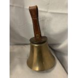 A LARGE BRASS BELL WITH LEATHER HANDLE