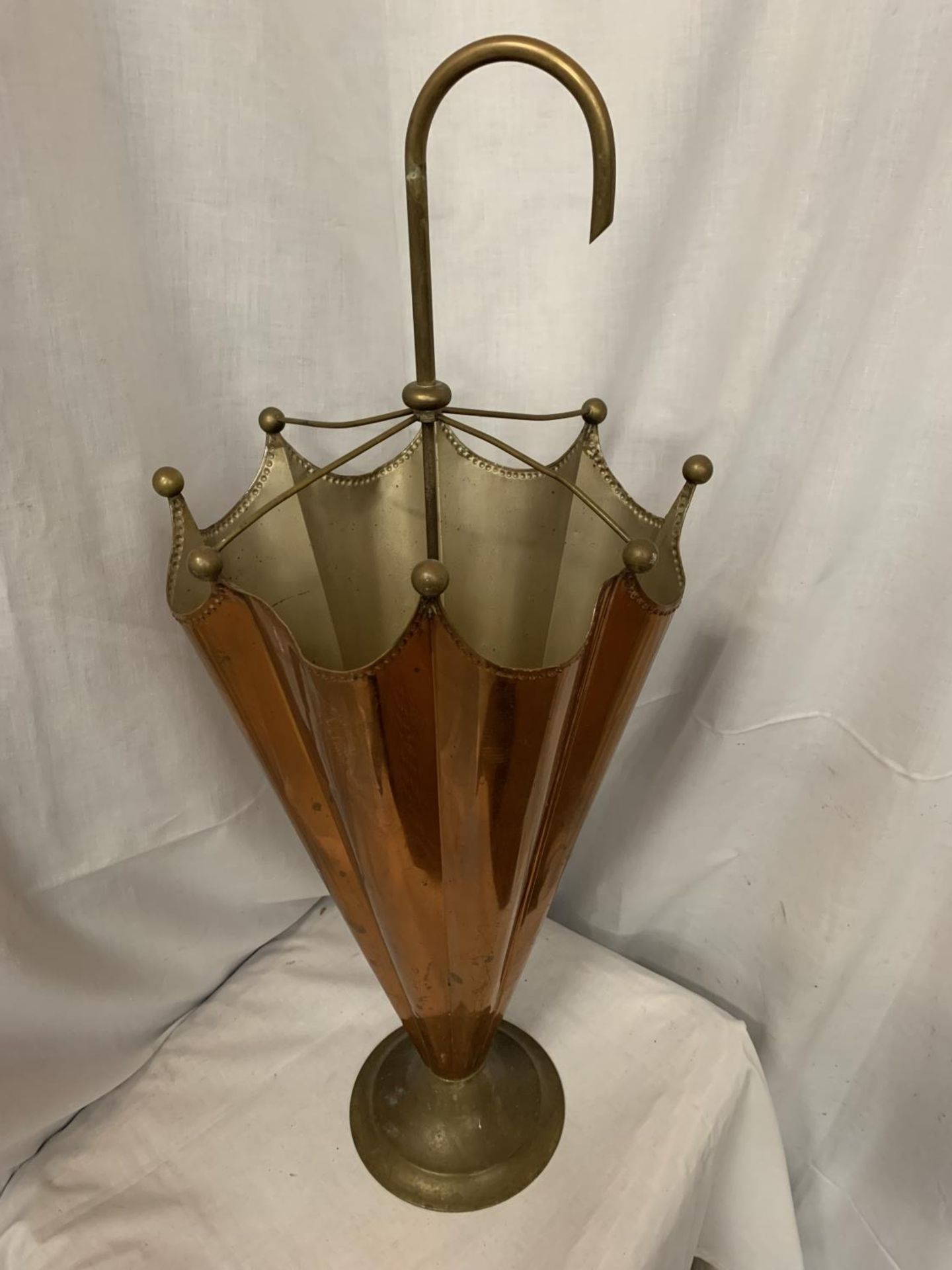 AN UNUSUAL COPPER AND BRASS UMBRELLA STAND IN THE FORM OF AN UMBRELLA
