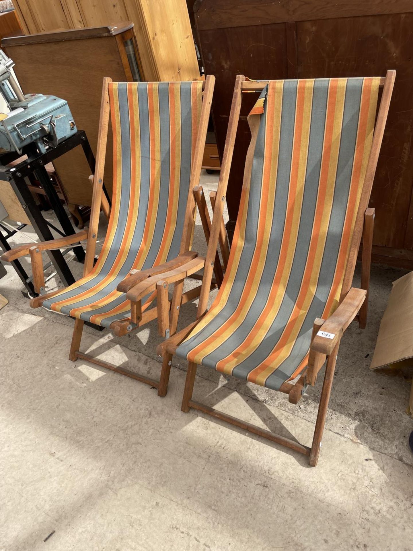 A PAIR OF WOODEN FRAMED FOLDING DECK CHAIRS