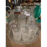 A PLATED TRAY WITH THREE DECANTERS AND THREE CUT GLASS TUMBLERS