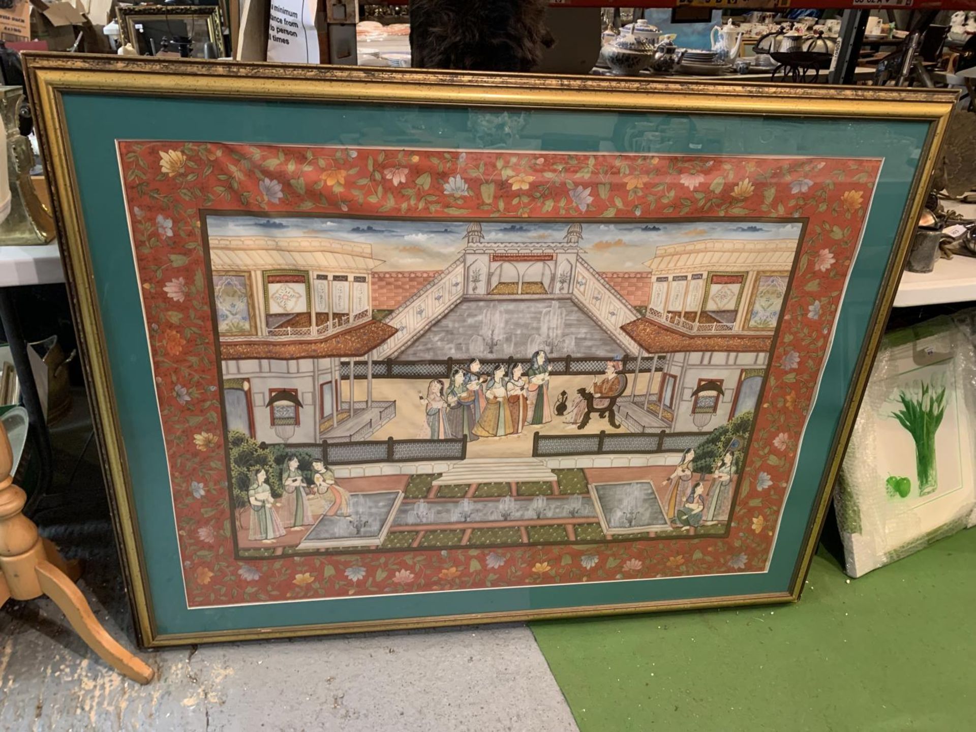 A FRAMED PAINTED SILK DEPICTING AN INDIAN SCENE