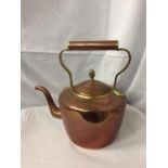 A BRASS AND COPPER KETTLE WITH ACORN TOP