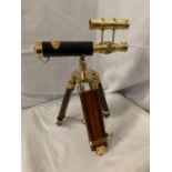 A BRASS AND LEATHER TELESCOPE ON A WOODEN TRIPOD STAND, 34CM HIGH