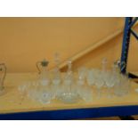 A LARGE COLLECTION OF GLASSWARE INCLUDING DECANTERS AND A VARIETY OF DRINKS GLASSES
