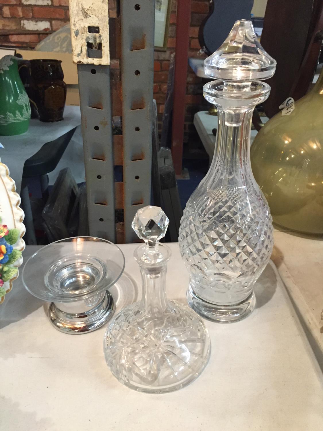 THREE ITEMS OF GLASSWARE TO INCLUDE A DECANTER, MINATURE DECANTER AND A DISH ON A CHROME BASE