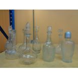 A COLLECTION OF NINE DECANTERS IN VARIOUS SHAPES AND SIZE