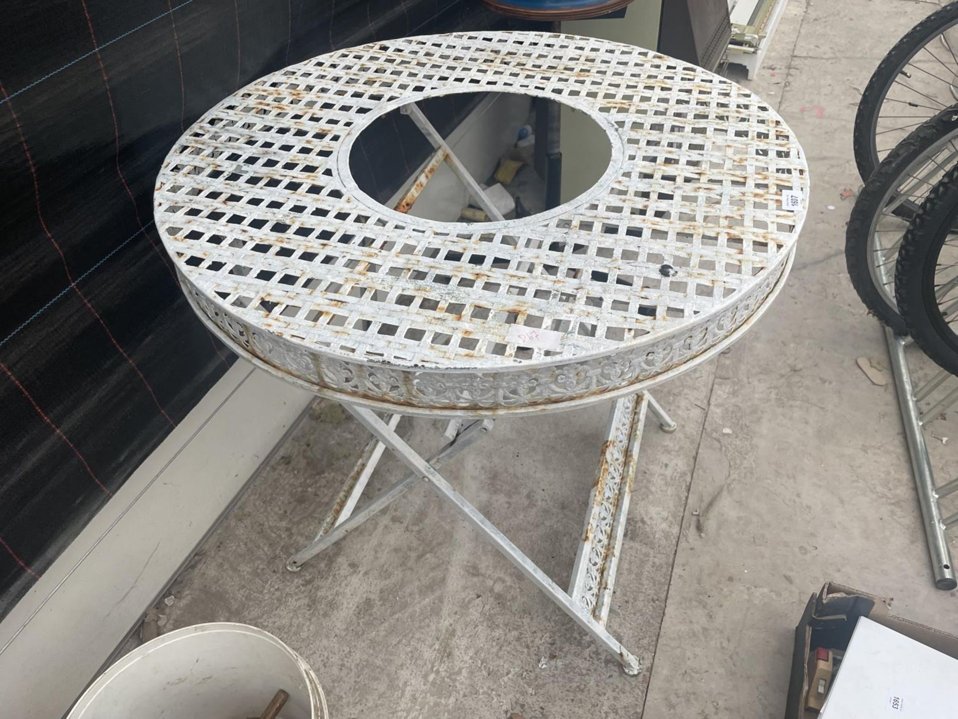 A WHITE PAINTED CAST ALLOY TABLE WITH OPEN CENTRE