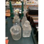 FOUR CUT GLASS ITEMS TO INCLUDE THREE DECANTERS AND A BISCUIT BARREL