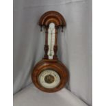 A SMALL ORNATE BAROMETER