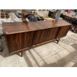 A RETRO HARDWOOD SIDEBOARD WITH FOUR SLIDING DOORS