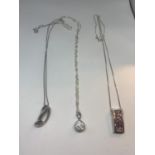 THREE SILVER NECKLACES TWO WITH PINK STONE PENDANTS AND ONE WITH A CLEAR STONE BALL