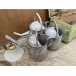 A GROUP OF THREE VINTAGE GALVANISED WATERING CANS