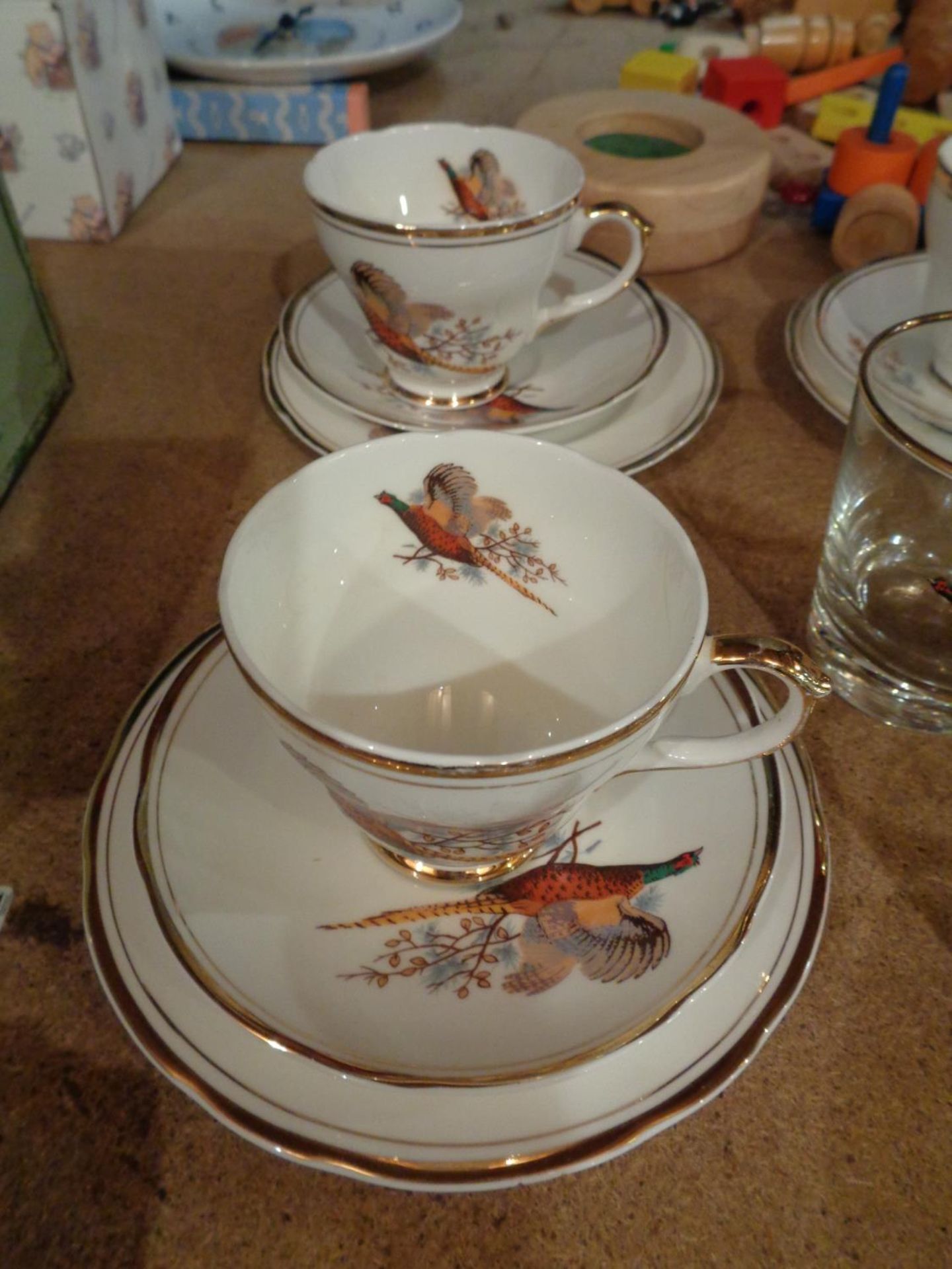 A SHERIDEN TEA SET OF SIX TRIOS AND MATCHING GLASSES IN A PHEASANT DESIGN - Image 2 of 4