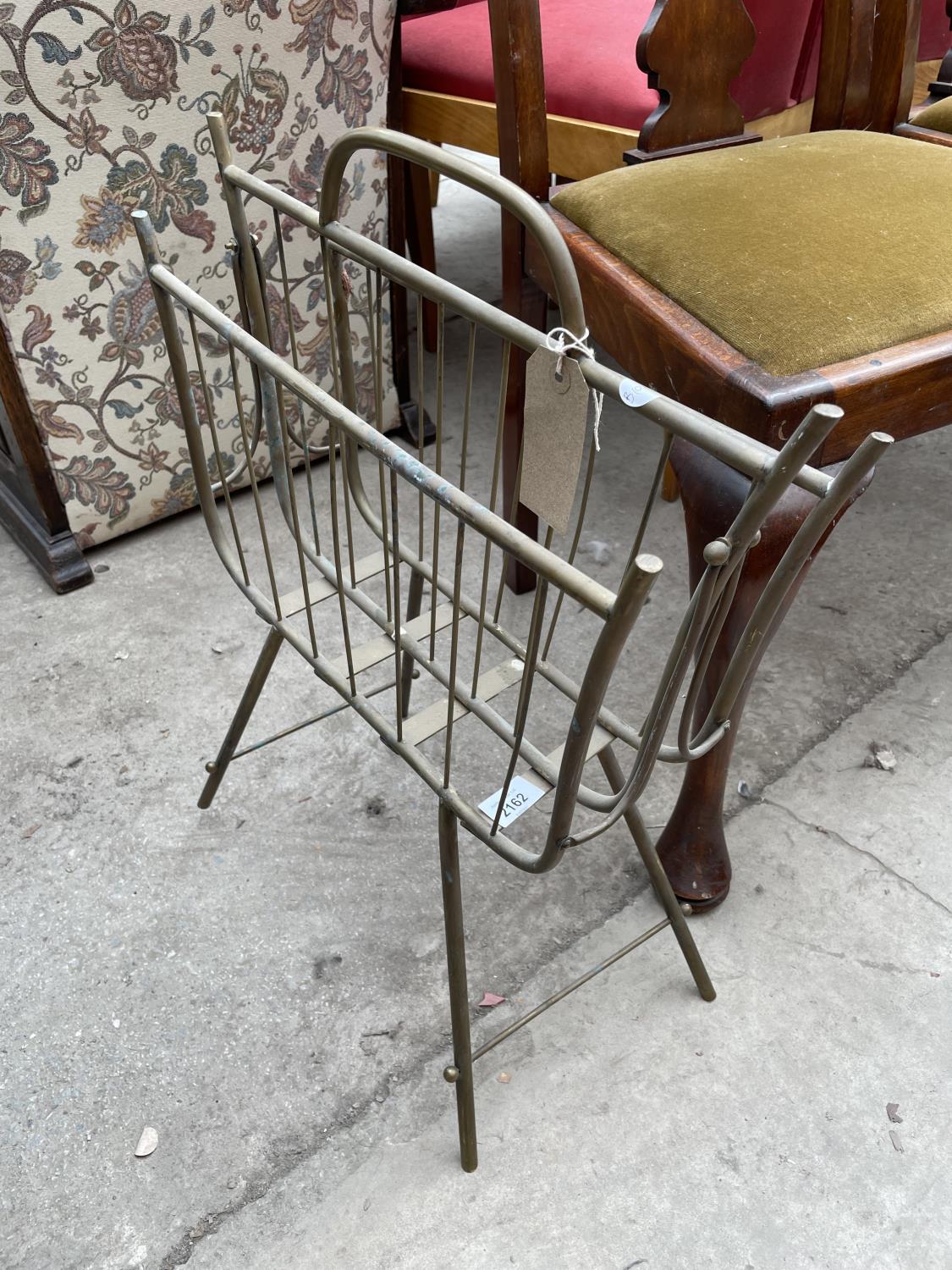 AN EDWARDIAN BRASS TWO DIVISION MAGAZINE/PAPER RACK