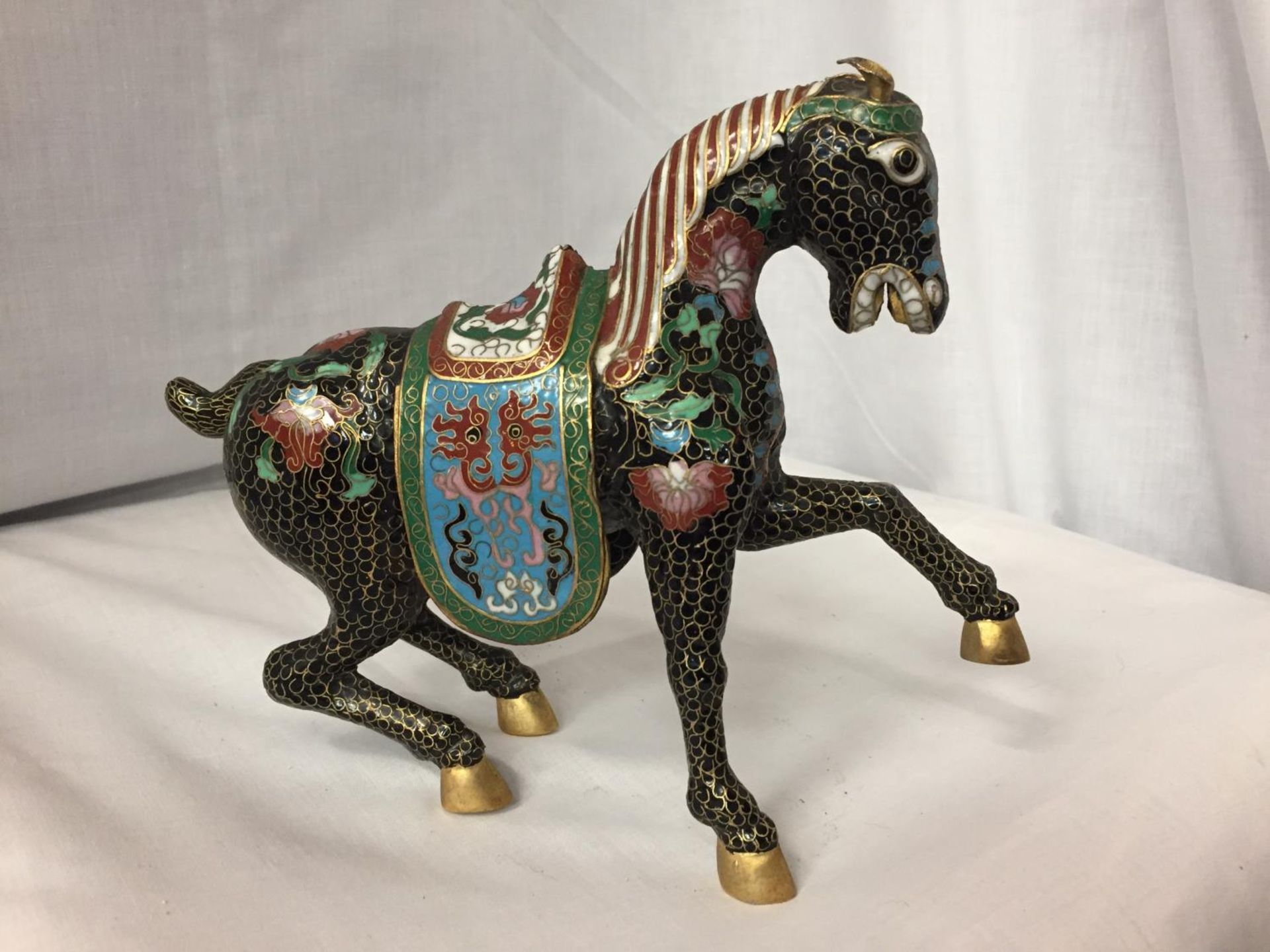 A CHINESE BRONZE CLOISONNE ENAMEL AND GILT HORSE