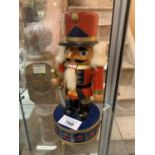 A STEINBACH STYLE NUTCRACKER ON A MUSIC BOX BASE