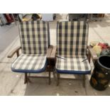 A PAIR OF TEAK FOLDING GARDEN CHAIRS