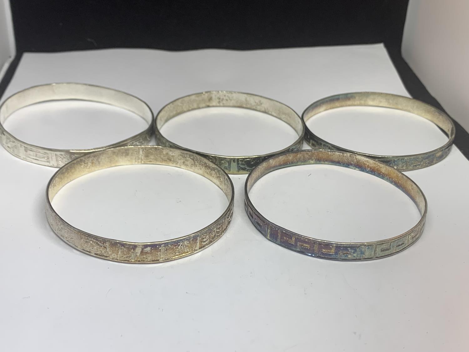 FIVE SILVER BANGLES WITH VARIOUS DESIGNS