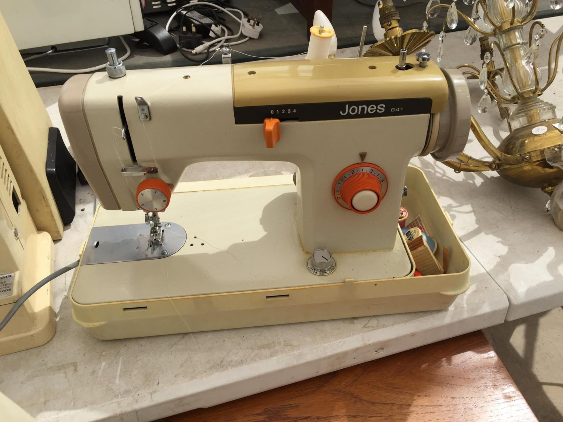 A JONES SEWING MACHINE WITH CARRY CASE AND FOOT PEDDLE