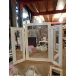 A WHITE FRAMED MODERN THREE SECTION DRESSING TABLE MIRROR