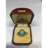 A SILVER RING WITH AN OVAL BLUE NAVAJO STYLE STONE