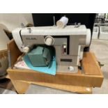 A NEW HOME SEWING MACHINE WITH CARRY CASE