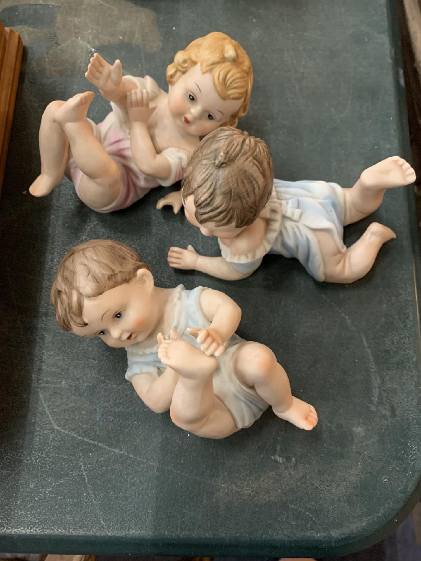 THREE PORCELAIN PIANO BABIES