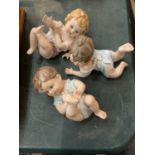 THREE PORCELAIN PIANO BABIES