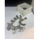 A SILVER CHARM BRACELET WITH ELEVEN CHARMS TO INCLUDE LANTERNS, RINGS, CARRIAGE, KEYS ETC WITH A